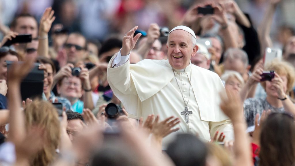 Pope Francis surrounded by pilgrims